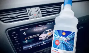 Flasche AdBlue neben dem Armaturenbrett. Fahrzeugstatus zeigt "Bitte AdBlue nachfüllen. Kein Motorstart in 300 km.