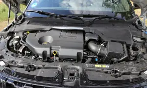 Motorraum eines Range Rover Evoque. Der Motor ist abgedeckt, aber die Leistung des Fahrzeugs, die durch die PS angegeben wird, ist spürbar.
