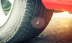 Ein Nagel steckt im Autoreifen. Zeit für einen auto reifen flicken, bevor die Luft entweicht.
