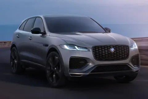 Grauer Jaguar F-Pace fährt am Meer entlang. Trotz seiner Eleganz gibt es manchmal Jaguar F-Pace Probleme.
